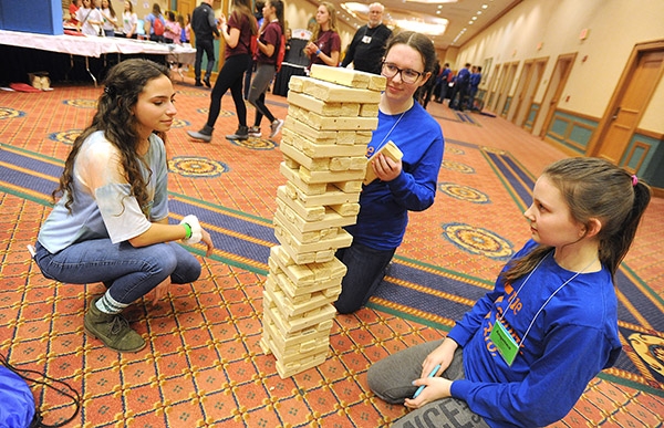 Members of the Chautauqua CYO, Anna Sena, 17, Chris Anne, 15, and Angelina Rand, 13, enjoy a game of jumbo Jenga during 